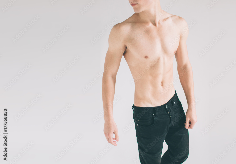 Man with young athletic muscular torso. Isolated on white background