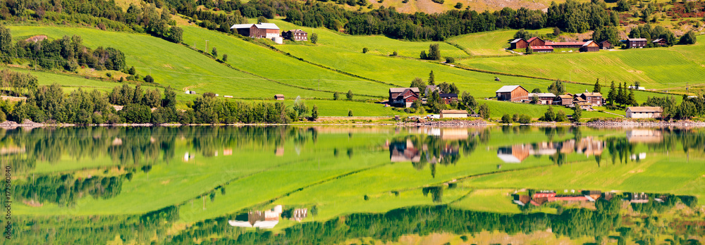 Norway country houses. Lake and meadows.
