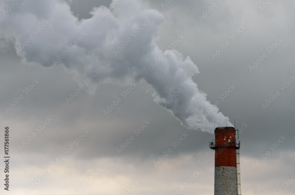 Smoke from the pipe. Against the gray gloomy sky. Smoke from the pipe. Against the gray gloomy sky.