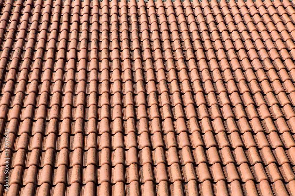 orange tile made of clay lying on the roof