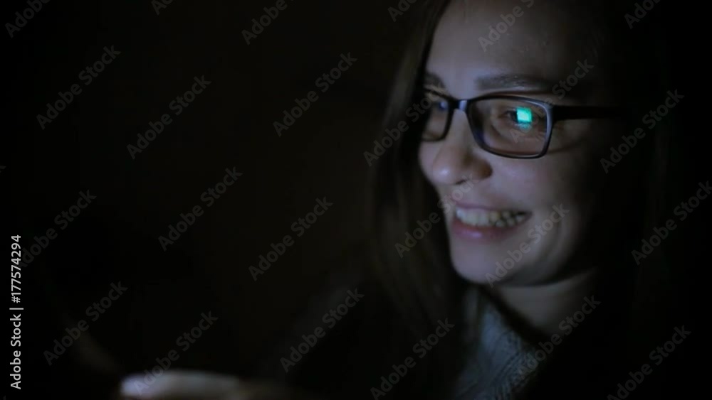 Beautiful woman using smartphone at home late night, very surprised, emotions Beautiful woman using smartphone at home late night, very surprised, emotions