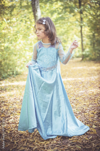 Portrait of beautiful little girl in blue dress