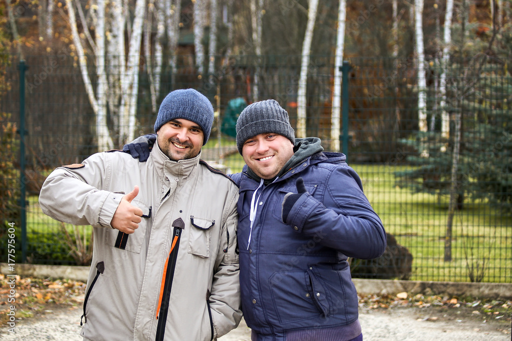 A portrait of two friends in warm sporty jackets A portrait of two friends in warm sporty jackets