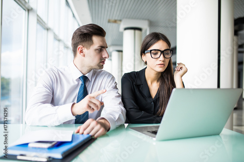 Portrait of investment advisor businesswoman consulting with young financial businessman.