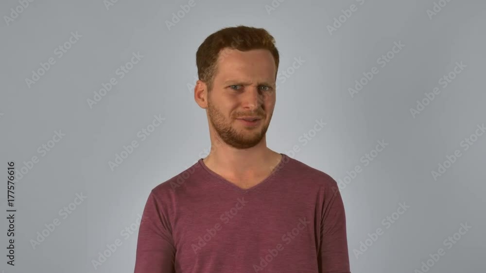 caucasian guy with red hair posing showing hand gesture fuck off handsome redhead men wearing in casual t- shirt. Portrait young caucasian man on grey background caucasian guy with red hair posing showing hand gesture fuck off handsome redhead men wearing in casual t- shirt. Portrait young caucasian man on grey background