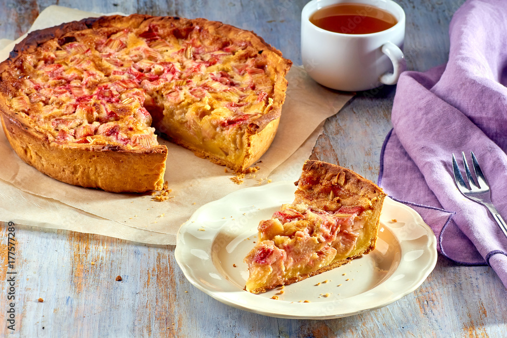 Homemade pie with rhubarb and custard on wooden table Homemade pie with rhubarb and custard on wooden table