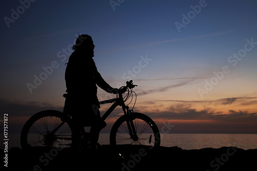 gün batımını izleyen bisikletli adam