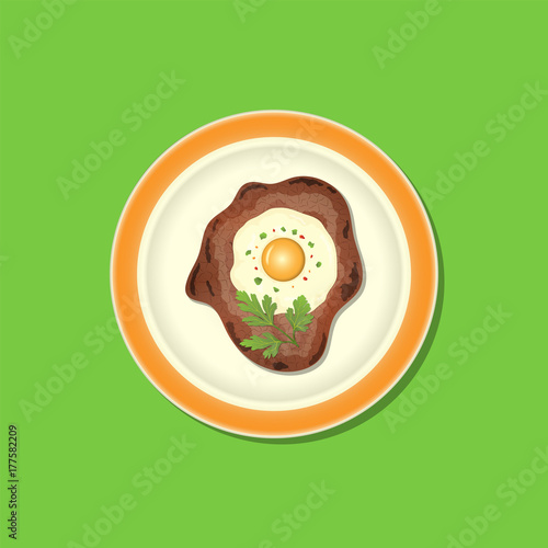 Fried meat with egg and parsley on the plate
