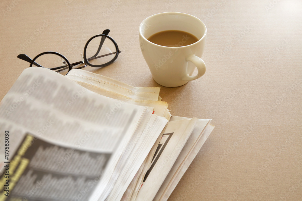 Newspaper with coffee on brown background Newspaper with coffee on brown background