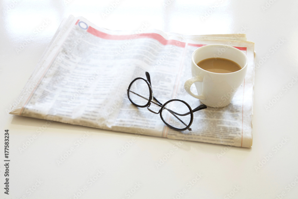 Newspaper with coffee on table Newspaper with coffee on table
