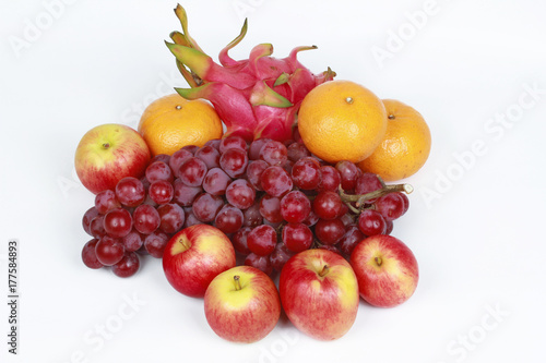 Mixed fruits as Red seedless grapes orange apple Dragon fruit Japanese golden melon.