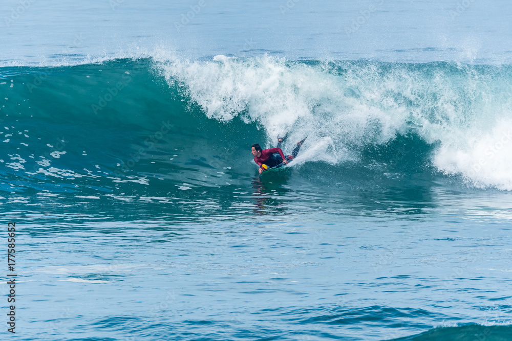 Bodyboarder surfing ocean wave