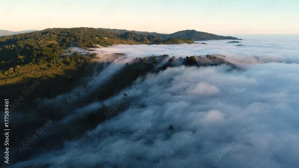Aerial drone shot of low laying clouds with setting sun close to the horizon Aerial drone shot of low laying clouds with setting sun close to the horizon