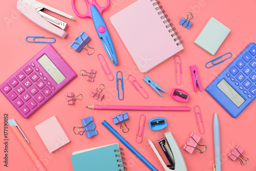 Stationary concept, Flat Lay top view Photo of school supplies scissors, pencils, paper clips,calculator,sticky note,stapler and notepad in pastel tone on pink background with copy space, flat lay 