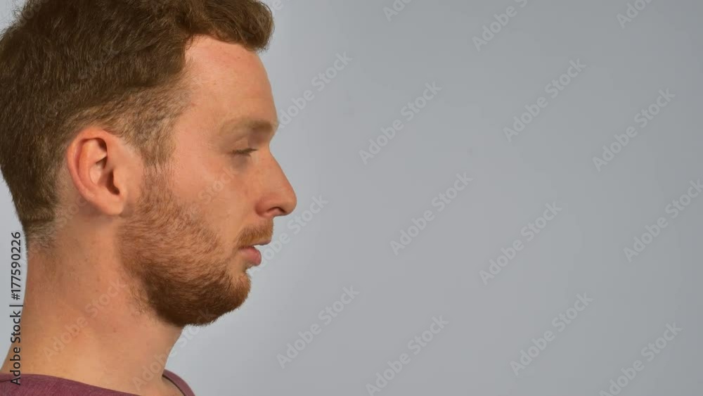 close up face in profile caucasian guy with red hair sneezing. handsome redhead men with beard. portrait young man on grey background has allergy or common cold close up face in profile caucasian guy with red hair sneezing. handsome redhead men with beard. portrait young man on grey background has allergy or common cold