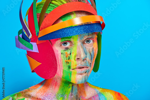 Model with colorful abstract makeup in multicolored helmet photo