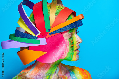 Model with colorful abstract makeup in multicolored helmet photo