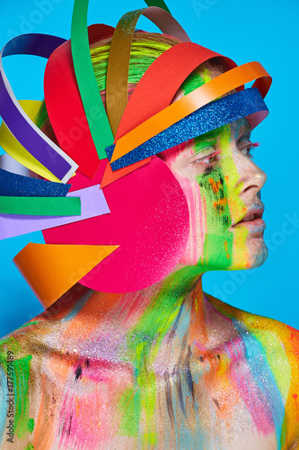 Model with colorful abstract makeup in multicolored helmet photo