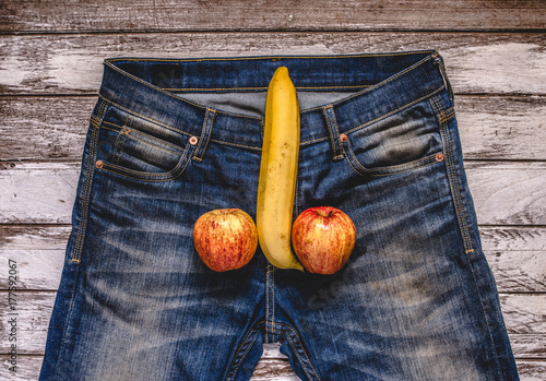 banana and apple out of mens jeans like mens penis. potency concept photo