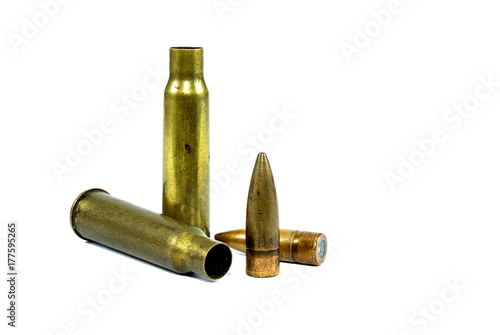 The ammunition was used. There is a bullet on the ground. Has a white background photo