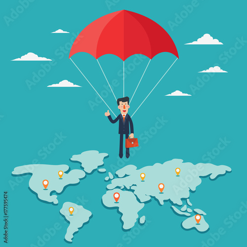 Successful business man with parachute over world map