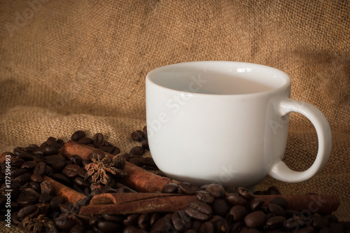 Coffee beans and cup coffee on the cloth sack select focus  Vintage color tone or dark tone