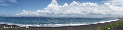 Panoramic view of black volcanic beach near blue sea in Bali island, Indonesia. photo