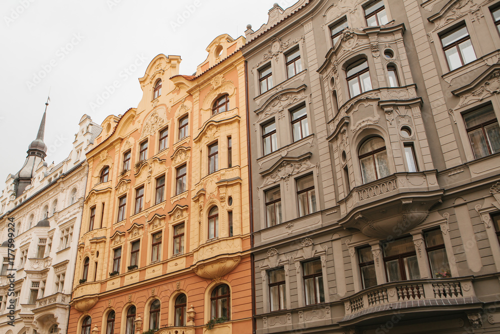 Traditional facade of buildings, exterior of buildings in Prague. Close-up of beautiful historic buildings standing tightly together