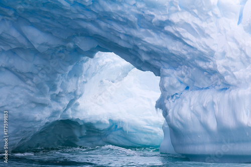 A huge cave has been carved in tho this iceberg.