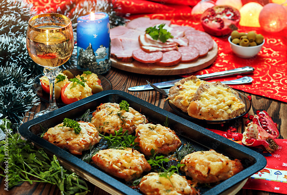Christmas baked chops with cheese and cold cuts platter, served on the old wooden table Christmas baked chops with cheese and cold cuts platter, served on the old wooden table