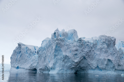 A huge iceberg has calved from a glacier. Showing beautiful blue ice