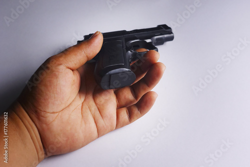 The Hand Of The Dead With Handgun Over White Background