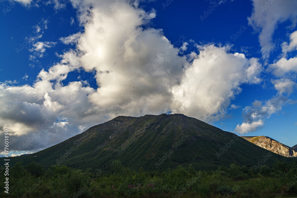 Top mountain Khibiny in the form of a background of the cloudy sky.