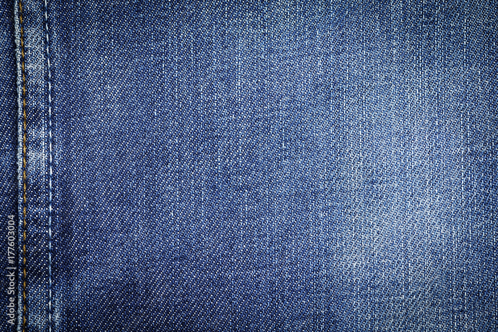 Naklejka premium Denim jeans fabric texture or denim jeans background with seam for beauty clothing. fashion business design and industrial construction idea concept.