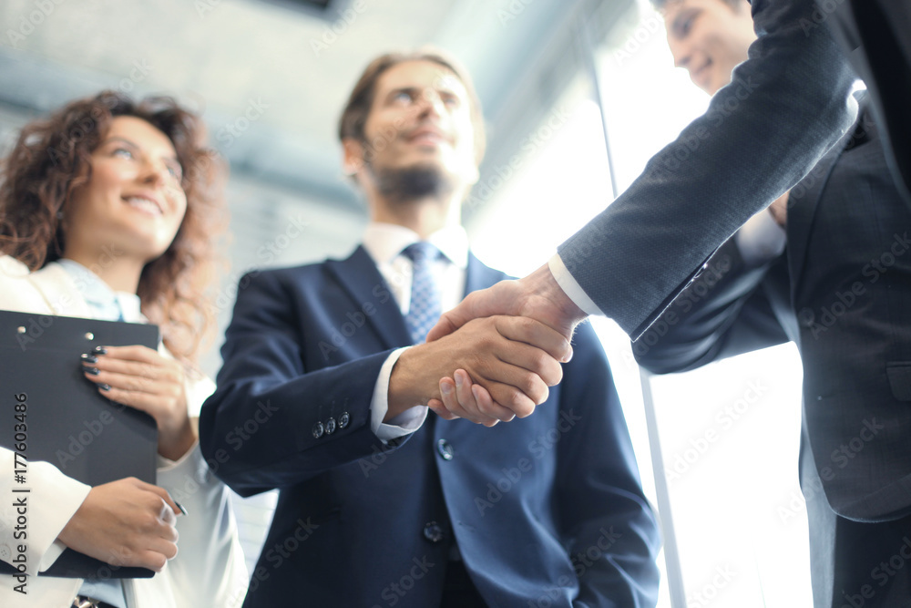 Business people shaking hands, finishing up a meeting. Business people shaking hands, finishing up a meeting.