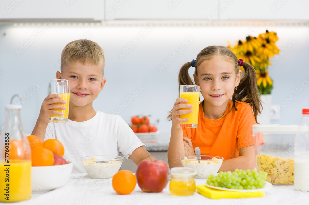 Children drink orange juice for breakfast Children drink orange juice for breakfast
