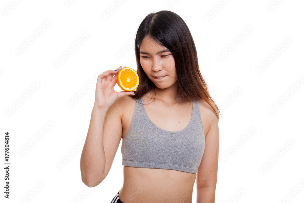 Beautiful Asian healthy girl with orange fruit licks her lips. Beautiful Asian healthy girl with orange fruit licks her lips.