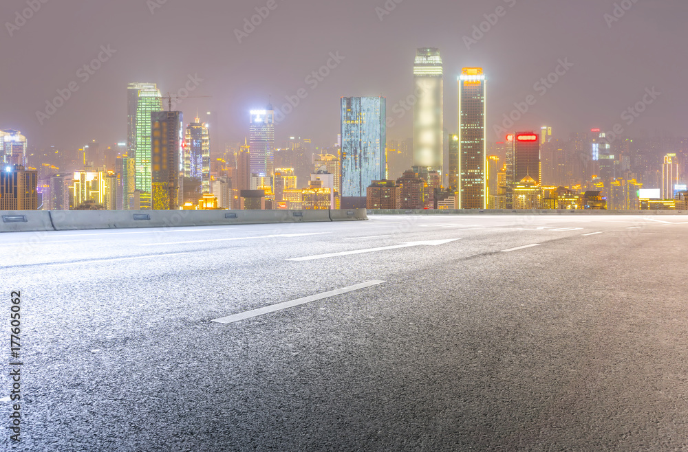 Fototapeta premium Road pavement and city skyline