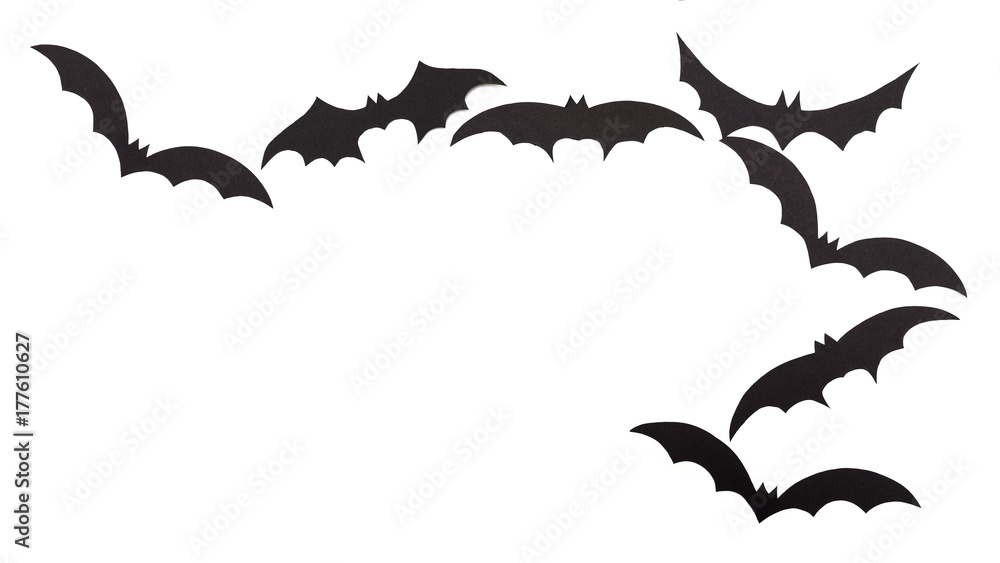 Silhouettes of volatile bats carved out of black paper are isolated on white Silhouettes of volatile bats carved out of black paper are isolated on white