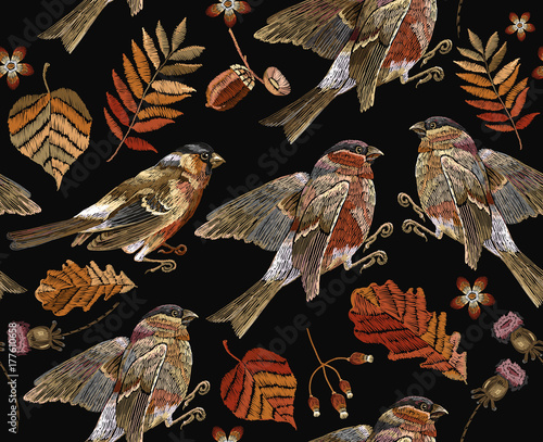 Embroidery autumn and birds seamless pattern. Fashionable template for design of clothes, t-shirt design. Classical september embroidery autumn leaves, bullfinch and titmouse.