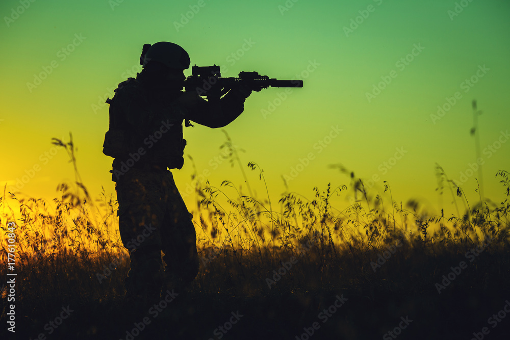military soldier with weapons at sunset. shot, holding gun, colorful sky. military concept. military soldier with weapons at sunset. shot, holding gun, colorful sky. military concept.