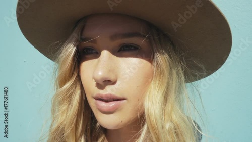 closeup young fashionista girl infont of turquoise wall. california lifestyle photo