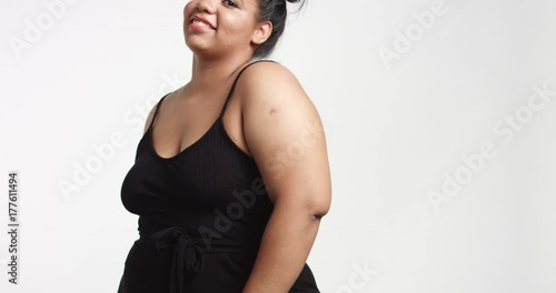 Strong confident beautiful plus size African American model in black one piece suit on white background photo