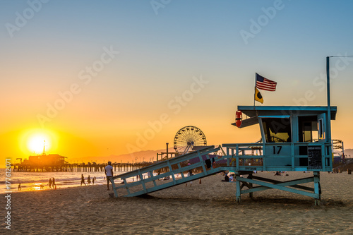 santa monica lifeguard tower and pacific park at background photo