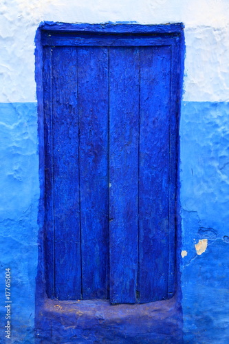 Old blue door of a house in Chaouen, Morocco photo