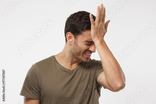 Tableau sur toile Disappointed stressed out guy making facepalm gesture with hand