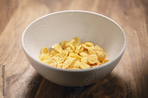 corn flakes in white bowl on table closeup