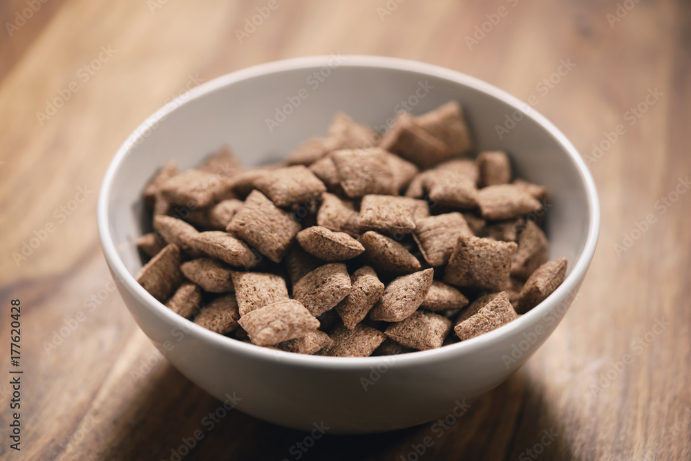 chcolate cereal pillow in white bowl on table chcolate cereal pillow in white bowl on table