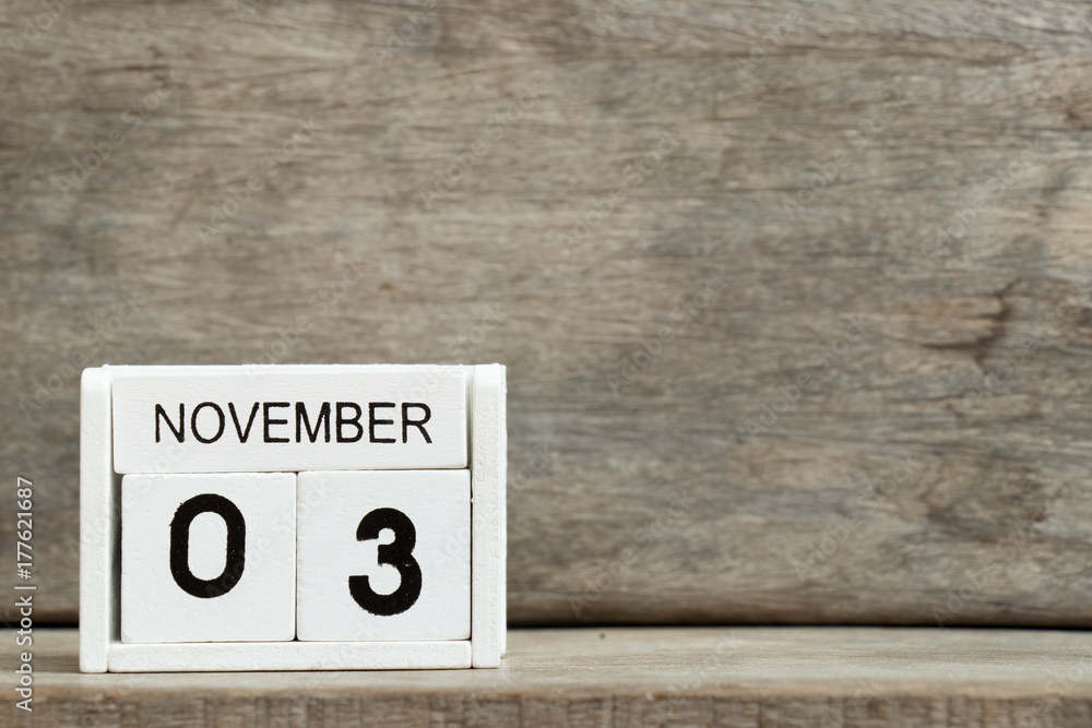 White block calendar present date 3 and month November on wood background White block calendar present date 3 and month November on wood background