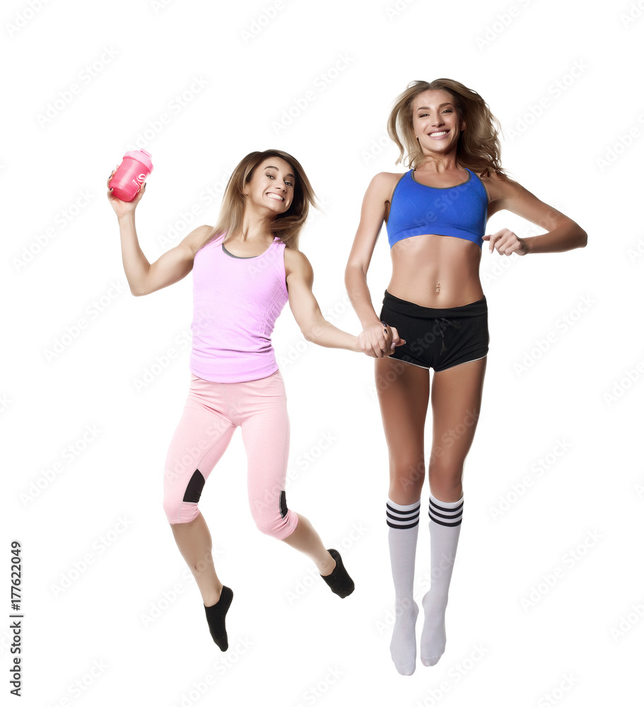 two jumping fitness girl on white background two jumping fitness girl on white background